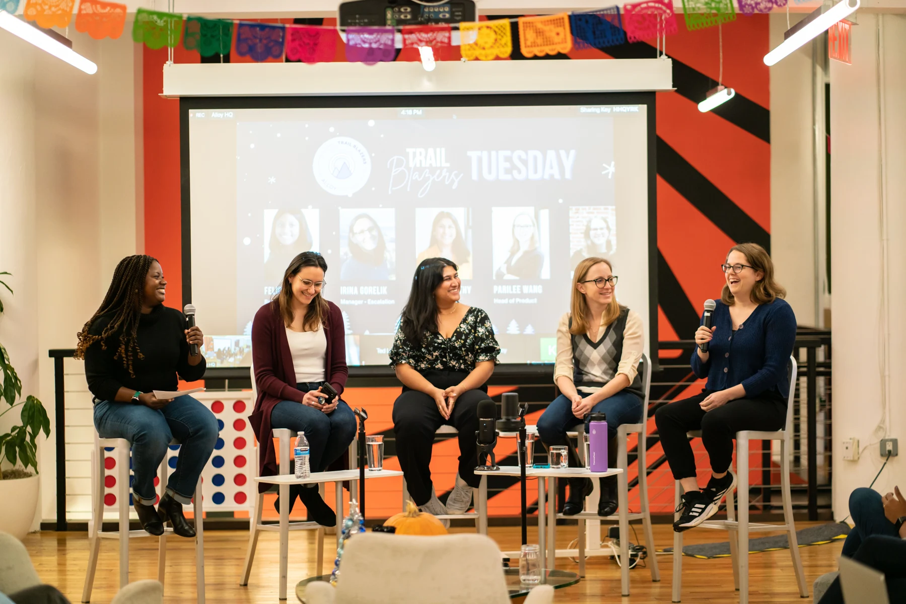 Real Alloy event photograph showing a panel discussion in front of an audience