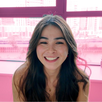 Futrproof founder Presence Plumb smiling in front of pink windows